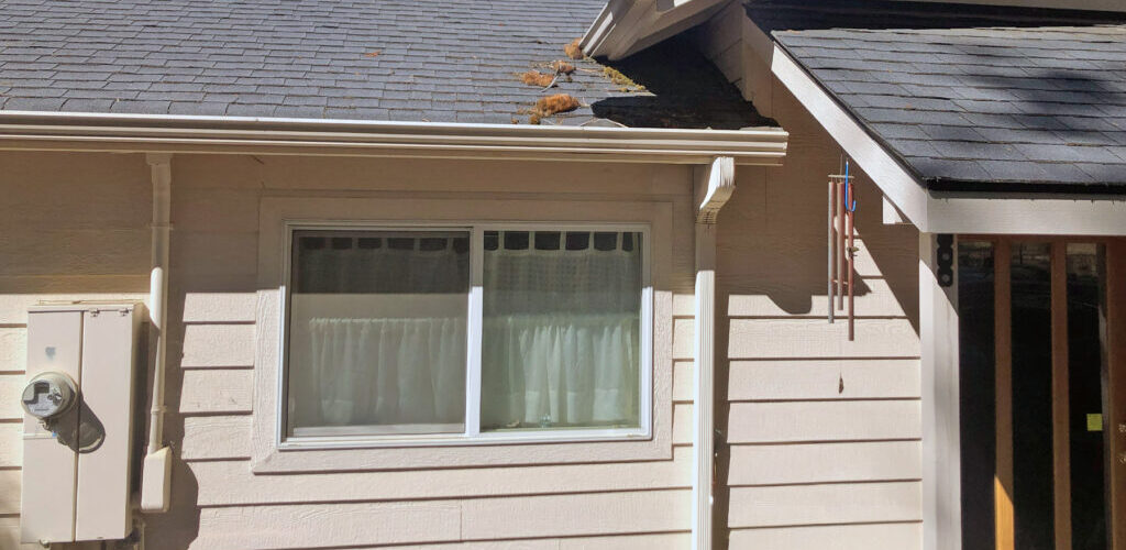 A house in Southern Oregon with rain gutters and downspouts for drainage