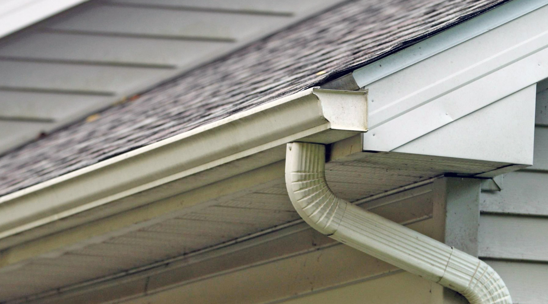 A roof with a gutter over the soffit and properly installed gutters preventing stains and drips